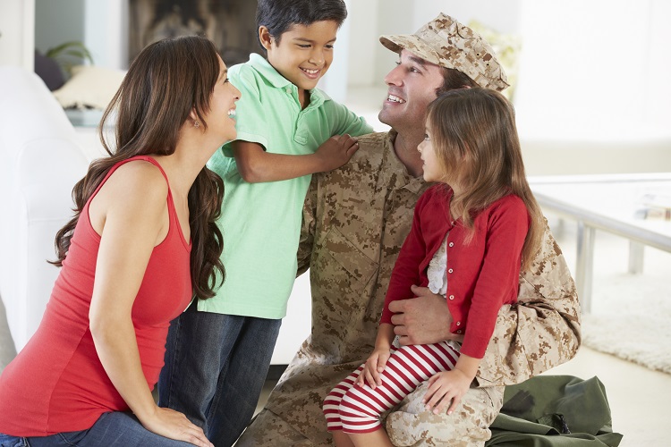 Family with dad in uniform, laughing and smiling