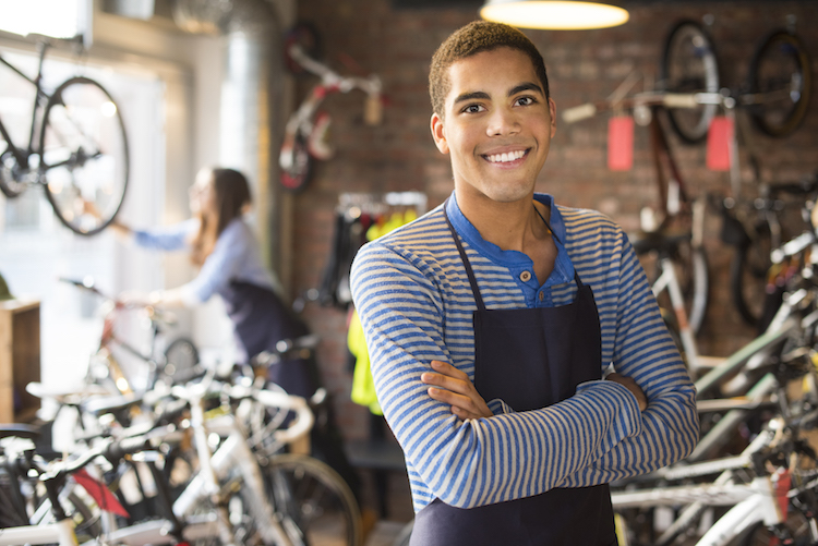 Young man working in a bicycle shop